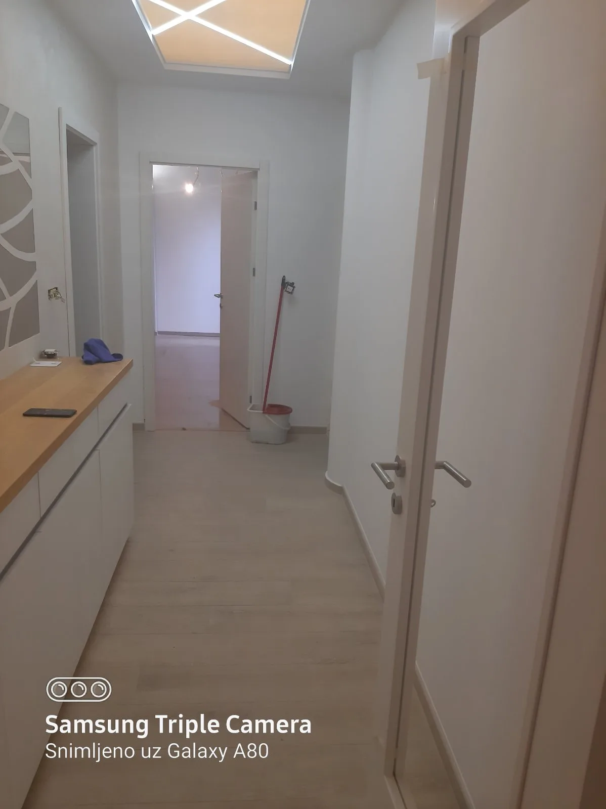 Hodnik sa ugradnom komodom i LED plafonom posle renoviranja stana u Beogradu — Adaptera